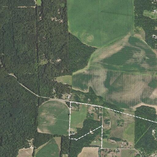 Smoldering hay bale fire in field near County Road 2730
