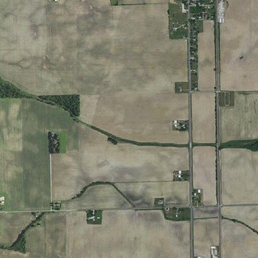 Truck losing gravel onto roadway and nearby vehicle in Urbana