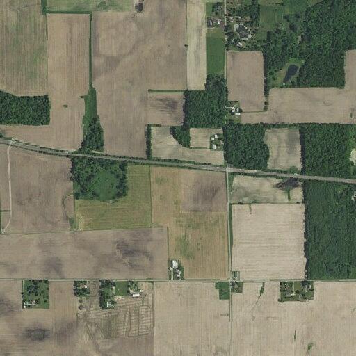 Large blue smoke near wooded area and tracks