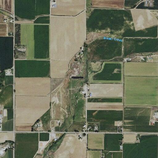 Brush fire between field and house near Bissel Creek