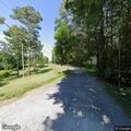 Large tree in power lines over roadway