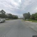 Person walking in road with cane and coffee in Maryland