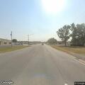 Person pushing cart in traffic lane