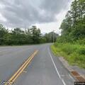 White SUV parked in roadway on Route 112