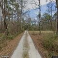 Car leaves roadway into woods near (street_name withheld)