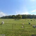 Person in white shirt walking near Huntington cemetery