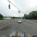 Disabled sedan blocking left lane at intersection