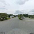 Person with head and back pain at municipal lot
