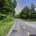 Officer checks stopped truck in road curve