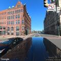 Person lying on ground near West Genesee Street