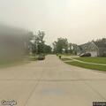 Man taking photos of houses on Lewis Avenue