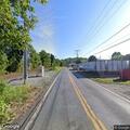 Live power line fire sparks brush near canal path