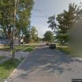 Loose black lab running near Central Drive