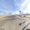 Man walking in roadway with shopping cart