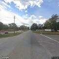 Woman walking in middle of roadway near highway
