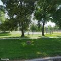 Male sleeping on bench at Russell Park shelter