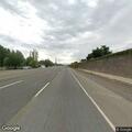 Person walking along freeway shoulder in Sunnyvale