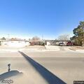 Injured dog lying in road near 13th and Hermosa