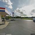 Vehicle drives off with gas nozzle causing fuel spill