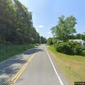 Tree blocks Route 12A and car smoking in roadway