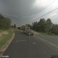 Suspicious activity around parked gray sedan