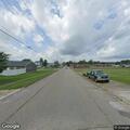 Vehicle hits parked car and light near railroad tracks