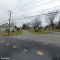 Man bleeding from head after bicycle fall at intersection
