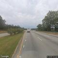 Beige sedan stopped in roadway at motel