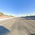Person standing outside gray car on Loop 101