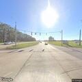 Traffic stop on tan pickup at highway intersection
