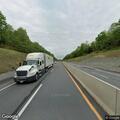 Disabled tractor-trailer with flat tire on highway