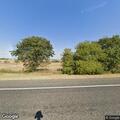 Grass fire near small church on State Highway 97