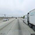 Person lying on freeway shoulder holding a knife