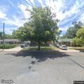 Suspicious gray sedan behind Chevron parking lot