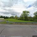 Female walking barefoot on road with hospital bands in Muncy