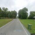 Male with feet hanging over overpass on Campground Road