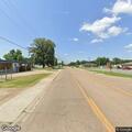 Person lying in street on bicycle in Marianna