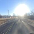 Dog lying in roadway at Vernon and Smith