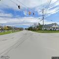 Person lying unconscious in grass at River Road