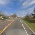 Disabled car partly over white line on Highway 63
