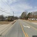 Officer checks white Nissan Versa at intersection