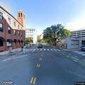 Older male in wheelchair in middle of street in Cambridge