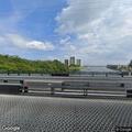 Woman on scooter weaving through traffic on bridge