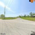 Man lying on roadside waving near Santa Claus highway
