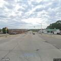 Pair walking in traffic and damaging sign