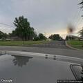 Officer conducts traffic stop on blue Toyota sedan