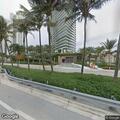 Person sleeping on bench at Collins Avenue