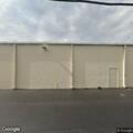 Person bathing with hose outside fitness business