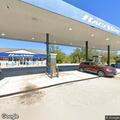 Man acting strangely in gas station parking lot