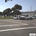 Person with sign creating traffic hazard on roadway